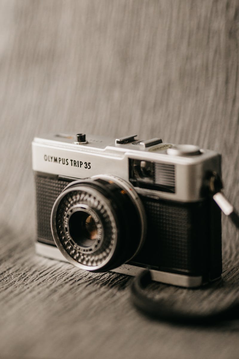 Close-up of a classic Olympus Trip 35 camera with a blurred background.